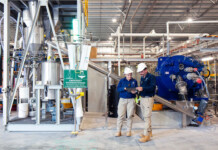 Alpha HPA scores $75 million for HPA First Project Two workers stand in high purity alumina facility