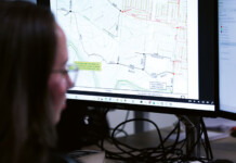 Harnessing neurodivergent minds in the energy sector Female analyst looks at computer screen with spatial data