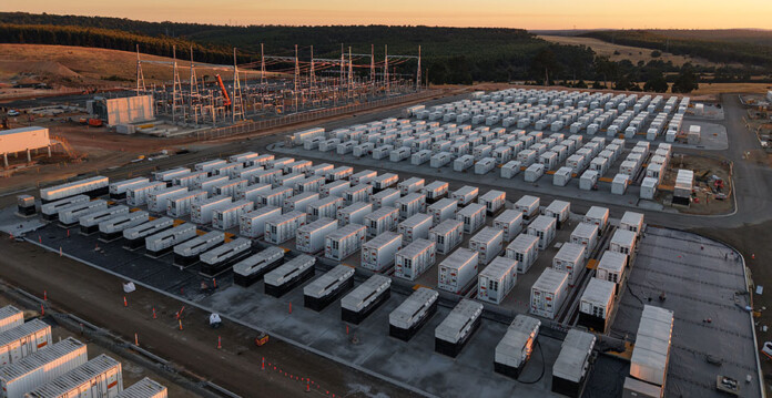 Aerial shot of battery energy storage system at dusk with golden sky overhead