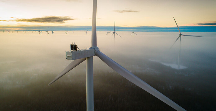 Vestas-turbine Wind turbines surrounded by clouds and sunset in the background