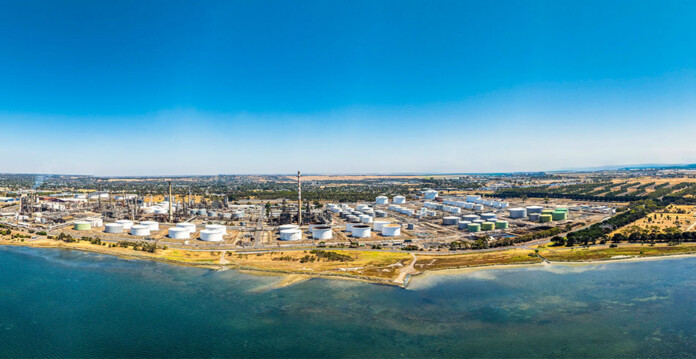 Aerial photo of the Geelong refinery with beautiful ocean and bright blue sky