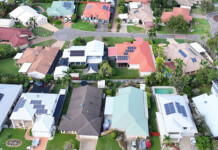 2026 Queensland Household Energy Survey now open Aerial shot of Queensland suburb with homes that have rooftop solar panels installed
