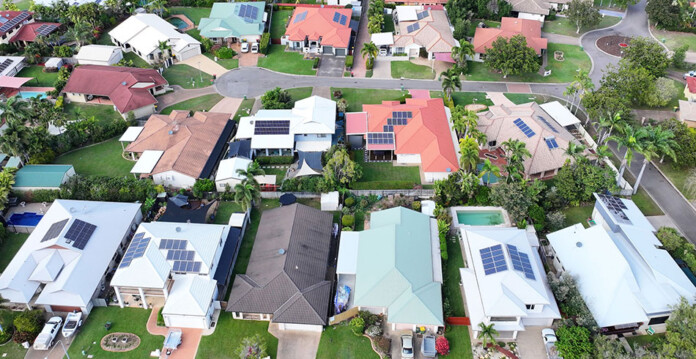 Aerial shot of Queensland suburb with homes that have rooftop solar panels installed