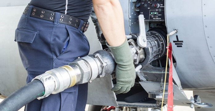Male aviation worker connects refueller to plane