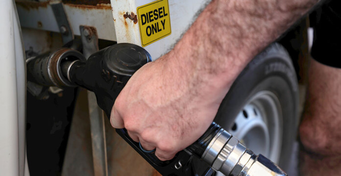 Close up of male filling diesel-only tank in vehicle