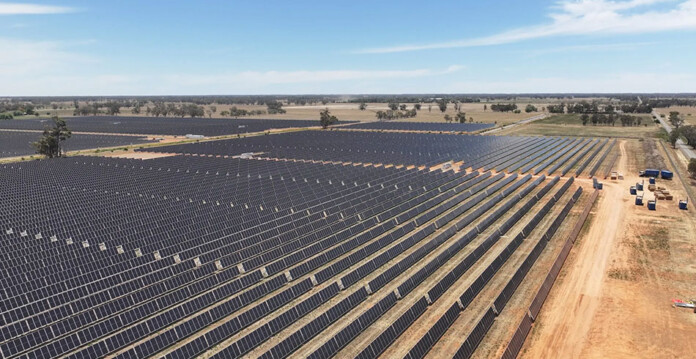 Aerial shot of massive solar farm with blue sky overhead