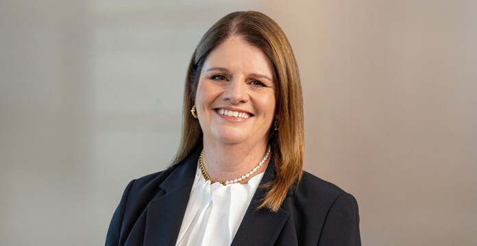 Smiling female executive wearing white shirt and black jacket