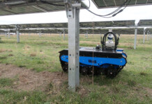 CSIRO trials robotic maintenance workers at large solar farms A small blue autonomous robot moves underneath solar panels at a solar farm