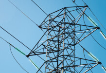 TAPR highlights vital transmission projects for SA’s growth Close-up of a high-voltage transmission tower with blue sky overhead