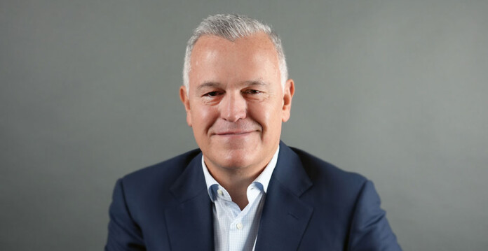 Head and shoulders shot of smiling male executive wearing suit