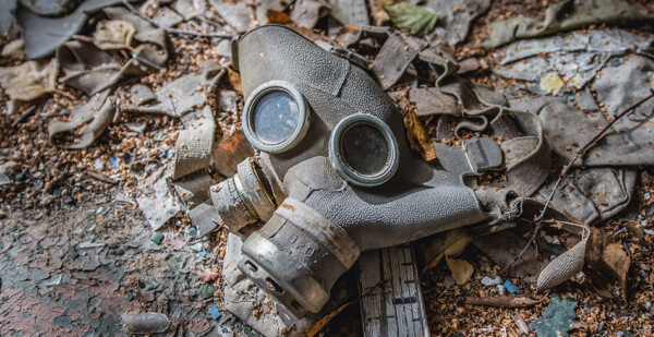 An old gas mask lies amongst rubble on the ground