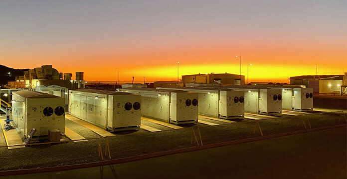 A battery energy storage system with beautiful sunrise in background