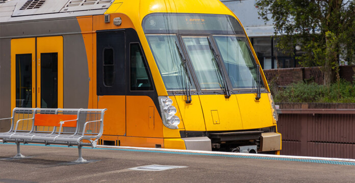yellow commuter train arrives at station platform