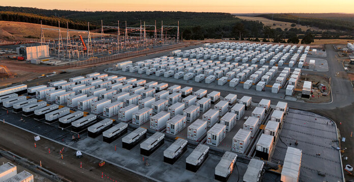Aerial shot of battery units at large battery storage project with sunset in background