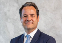 Woodside appoints new chief operating officer Australia Head and shoulders shot of smiling male executive wearing a suit and tie