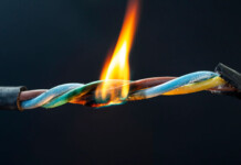 Underinvestment in voltage management is costing Australians energy consumers billions Close up shot of a flame burning a frayed electrical wire
