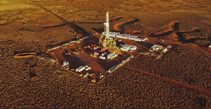 Aerial shot of hydraulic fracture equipment in arid outback region