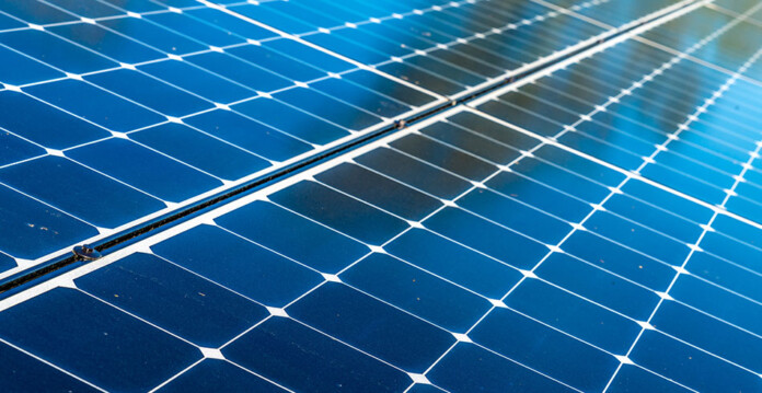 Close-up of solar panels with sun shining on them