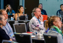 Energy leaders gather in Noosa to work on big issues Executives sit in conference room listening to a presentation