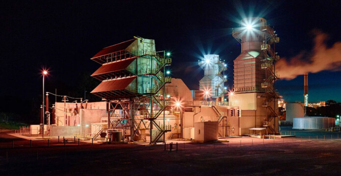 gas-fired power station lit up at night time