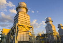 Sembcorp completes acquisition of Alinta Energy huge gas-fired power station with blue sky and white clouds overhead