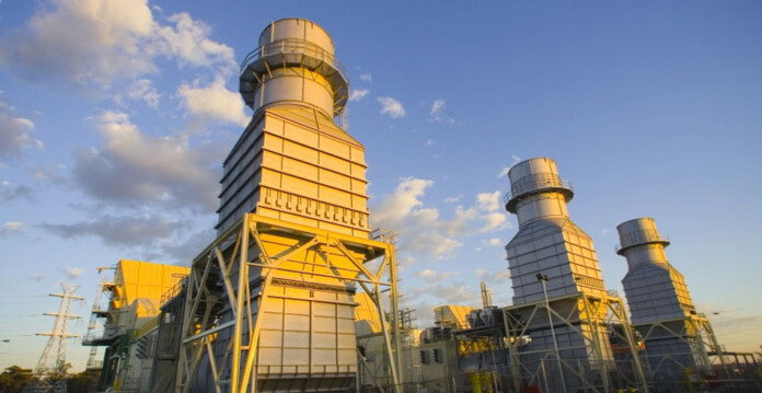 huge gas-fired power station with blue sky and white clouds overhead