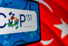 Australia backs 35% by 2035 global electrification target Smartphone with COP31 logo on screen and a Turkish flag in the background