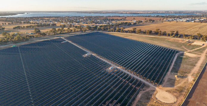 Aerial shot of large-scale solar farm with horizon overhead