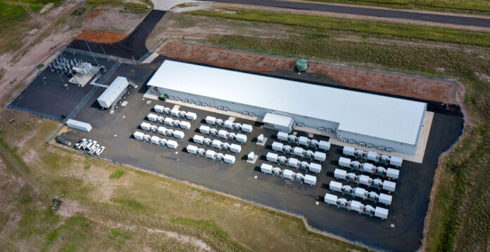 Aerial photo of battery units at a battery storage energy system surrounded by grassy landscape