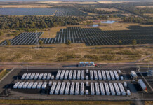 Neoen inks virtual battery contracts for Western Downs Rendered image of large battery project with battery units in foreground and solar farm in background