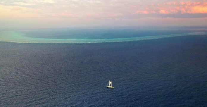 Photo of Greenpeace sailing vessel near beautiful Scott Reef in the ocean