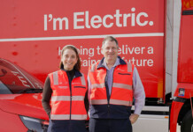 Australia Post accelerates shift to electric trucks and vans Australian Minister for Communications Anika Wells and Australia Post Executive General Manager, Network Operations Shane Plant pose for photo in front of bright red electric truck