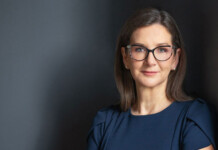 Australian Energy Regulator becomes standalone agency Head and shoulders shot of a woman with dark brown hair and dark-framed eyeglasses in a navy blouse leaning against a dark wall