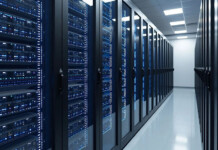 Data centre boom won’t mean higher power prices—if we unlock stalled renewable projects Aisle with servers inside brightly lit data centre