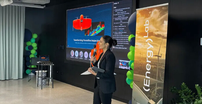 Woman in black suit speaking at an energy innovation program event