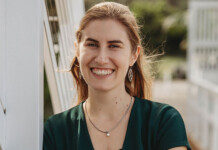 5 Minutes With: IEEFA’s Johanna Bowyer Head and shoulders shot of smiling woman wearing dark green dress outside in sunshine