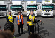 Volvo rolls out first Australian-made OEM electric trucks Prime Minister Anthony Albanese delivers speech to crowd with line of electric Volvo trucks behind him