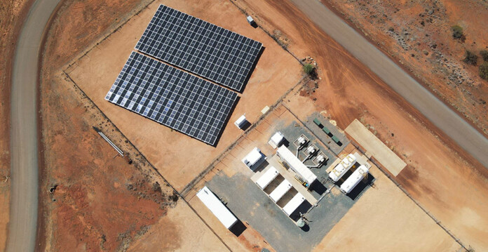 Aerial photo of solar farm and battery energy storage system set in red dirt of remote regional town