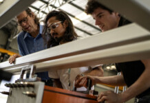 Partnership to accelerate Allegro Energy’s flow battery tech Three men examine flow battery technology in a production facility