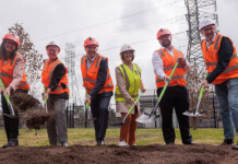 Work begins at first of eight batteries in Western Sydney Energy executives in safety gear and hard hats hold shovels as they turn ground at the site of a battery storage system
