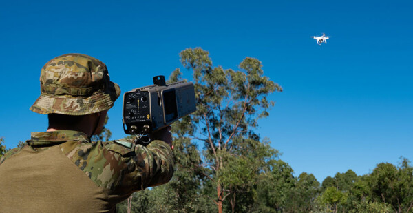 Soldier aims specialised gun at drone in the sky 