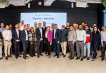 Partnership powers next generation of energy engineers Cohort of male and female engineers and executives at a partnership signing ceremony