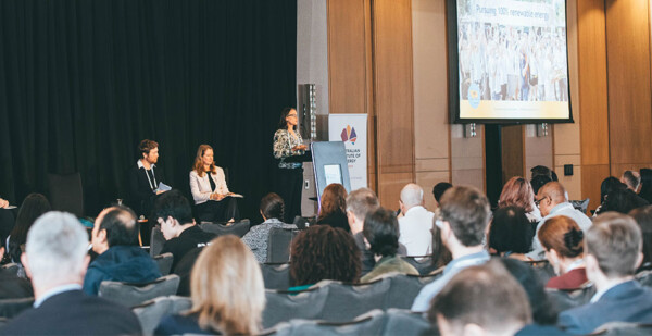 Female energy executive speaks at a lectern to audience at an energy conference
