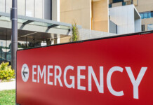 Electrifying Australian hospitals could save $59M per year Red emergency sign out the front of a modern hospital in Australia