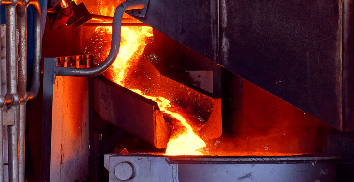 Hot metal flows from an electric smelter in a factory