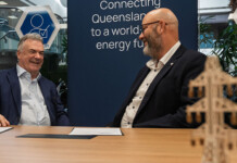 Powerlink awards second contract for CQ transmission line Two male executives in conversation during contract signing event