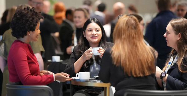 Female energy executives chatting and enjoying breakfast at an event