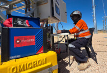 Built by industry for industry—the Brandis Hire difference Male worker in high-vis workwear sits near Brandis Hire-branded equipment on a job site