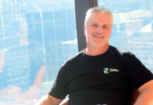 5 Minutes With: Zinfra’s James Quigley Zinfra's James Quigley wears black Zinfra shirt while sitting in a chair in front of an office window overlooking a city view