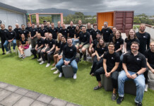 Gridsight raises $36M to accelerate US expansion plan Large group of Gridsight staff pose for photo on office rooftop with grey sky overhead